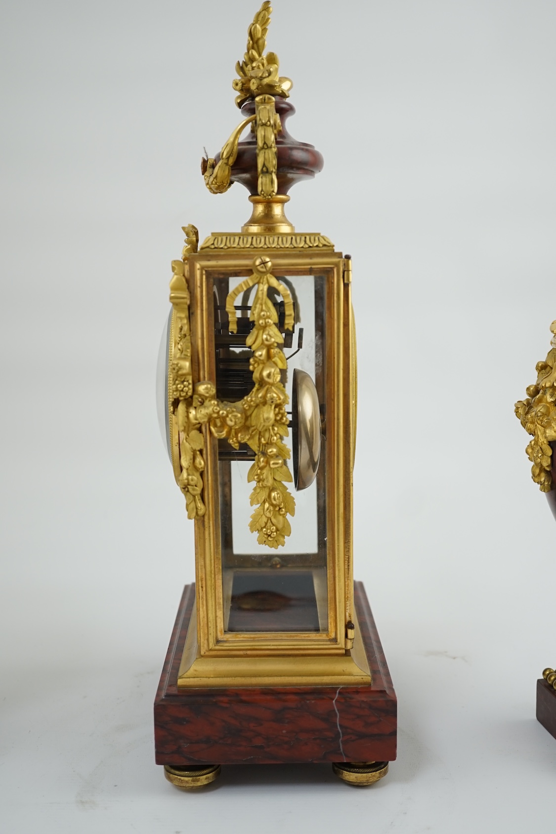 Revel à Paris. A 19th century French ormolu and rouge marble clock garniture